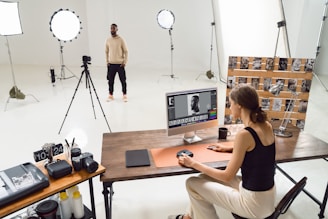A photographer edits photos in a studio.