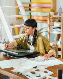 Artist works on a digital tablet in her studio.