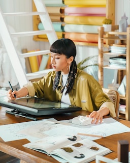 Artist works on a digital tablet in her studio.