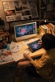 Artist creating digital art on a desk.