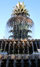 A beautiful pineapple fountain with water flowing downward.