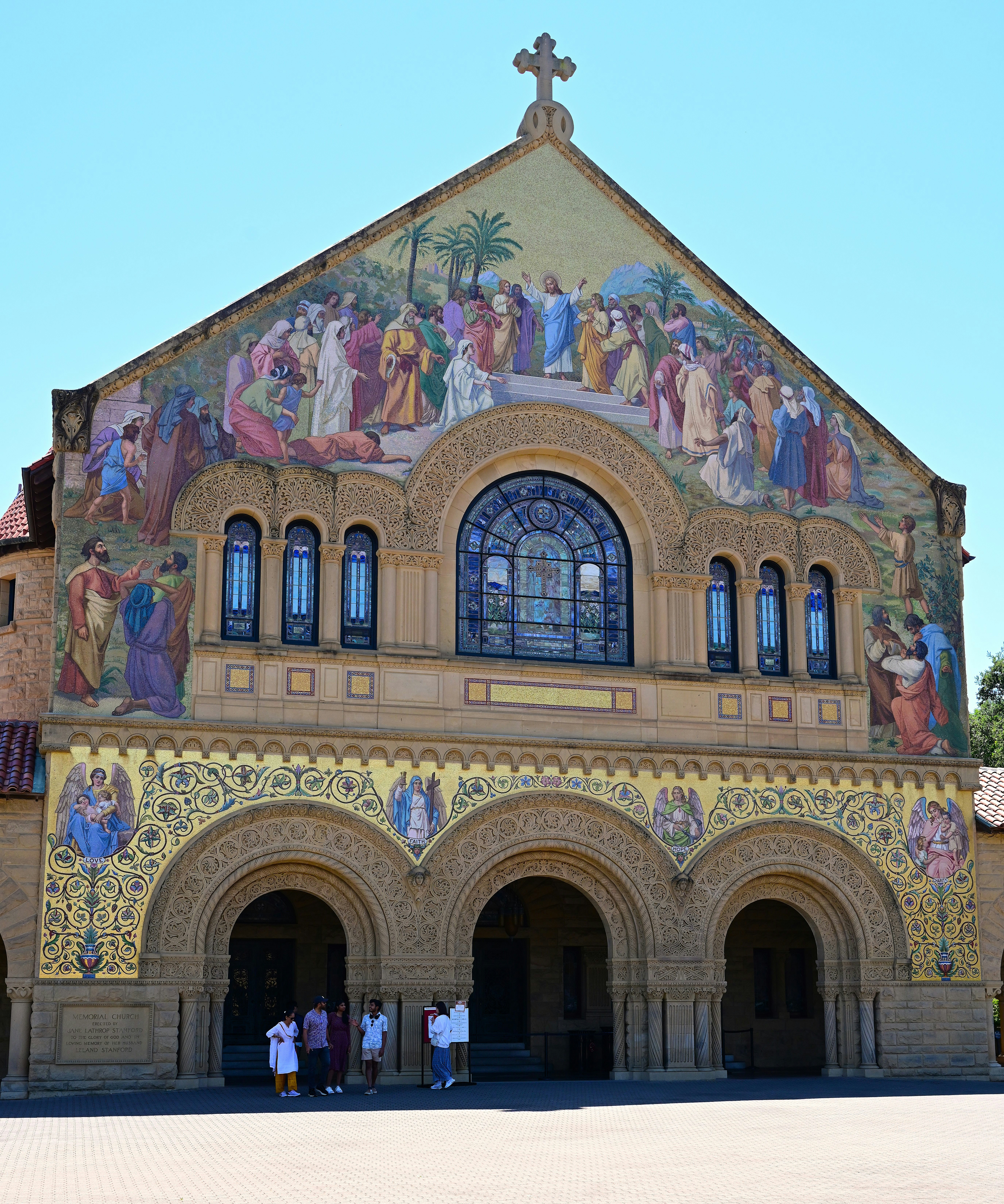 A detailed church with intricate mosaics on its facade.