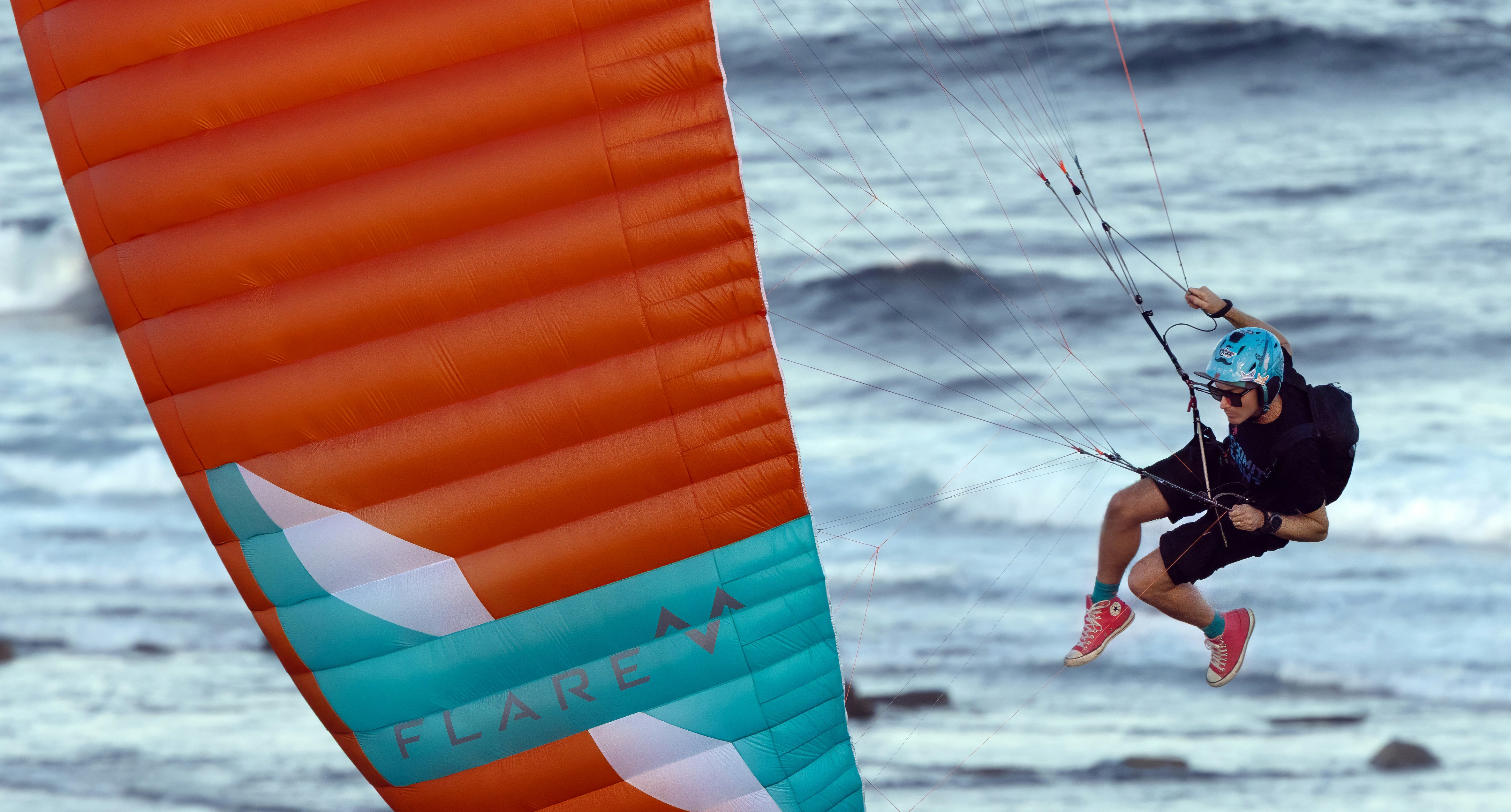 Kitesurfer in action with his kite above the water.
