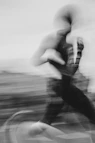 A blurred person is riding a bicycle.