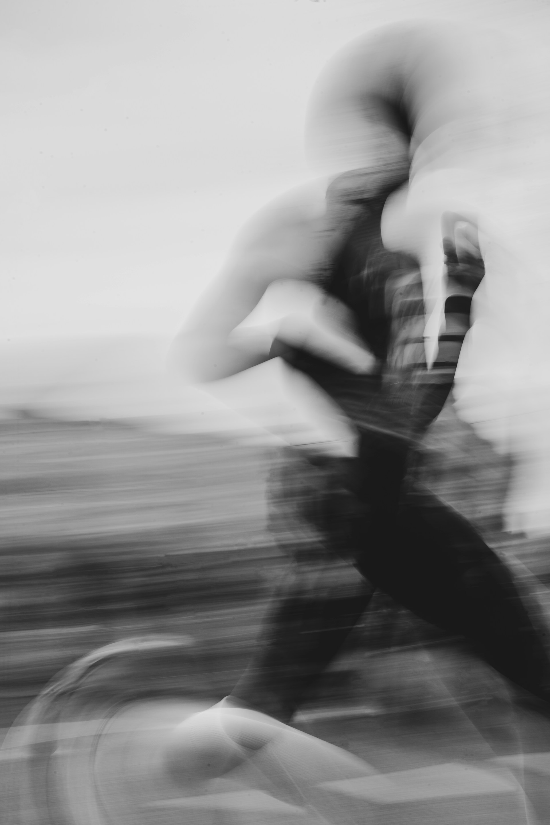 A blurred person is riding a bicycle.