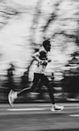 A runner is captured in motion with a blurred background.