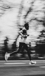 A runner is captured in motion with a blurred background.