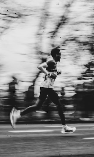 A runner is captured in motion with a blurred background.