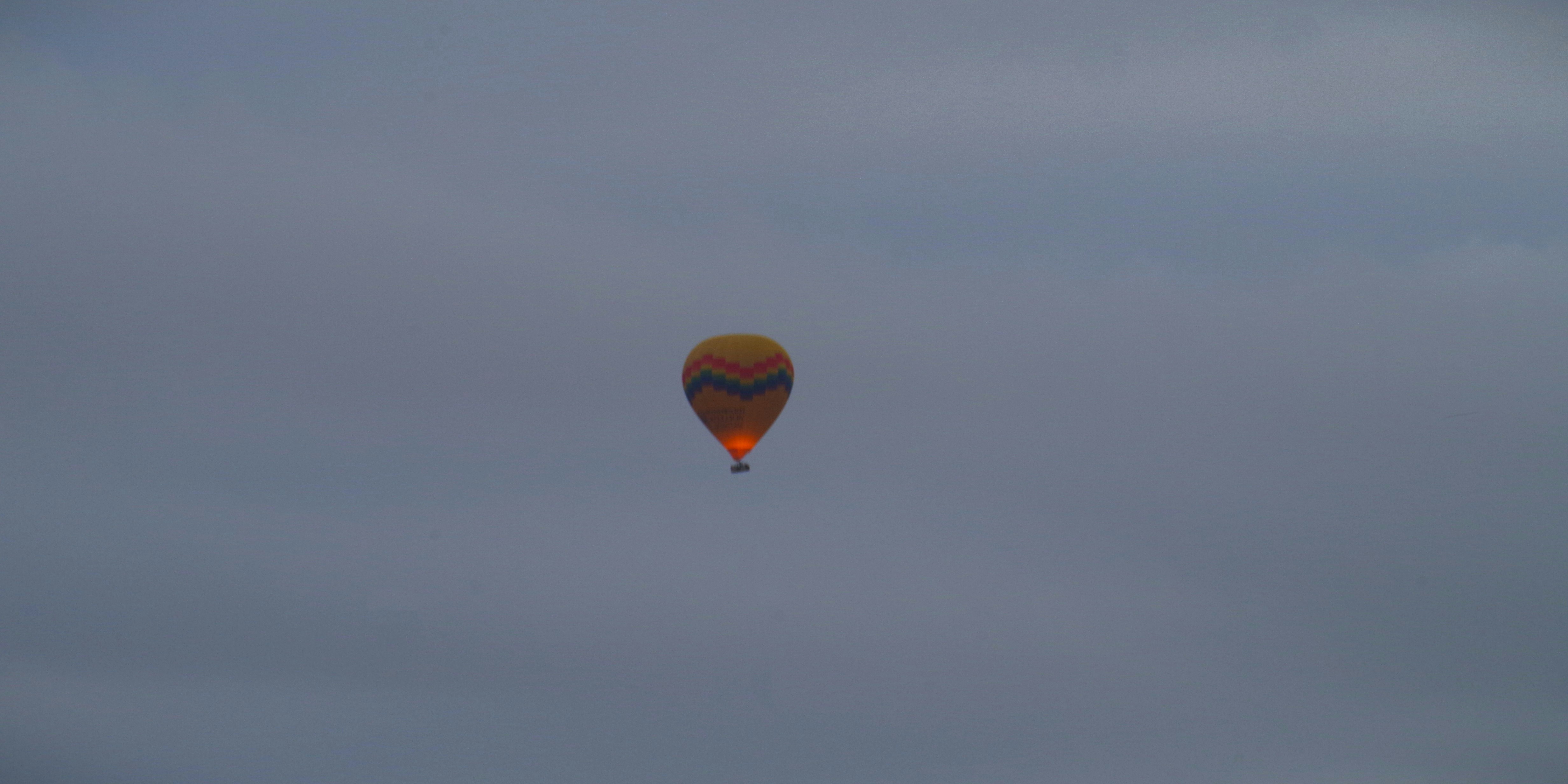 A hot air balloon ascends in the sky.