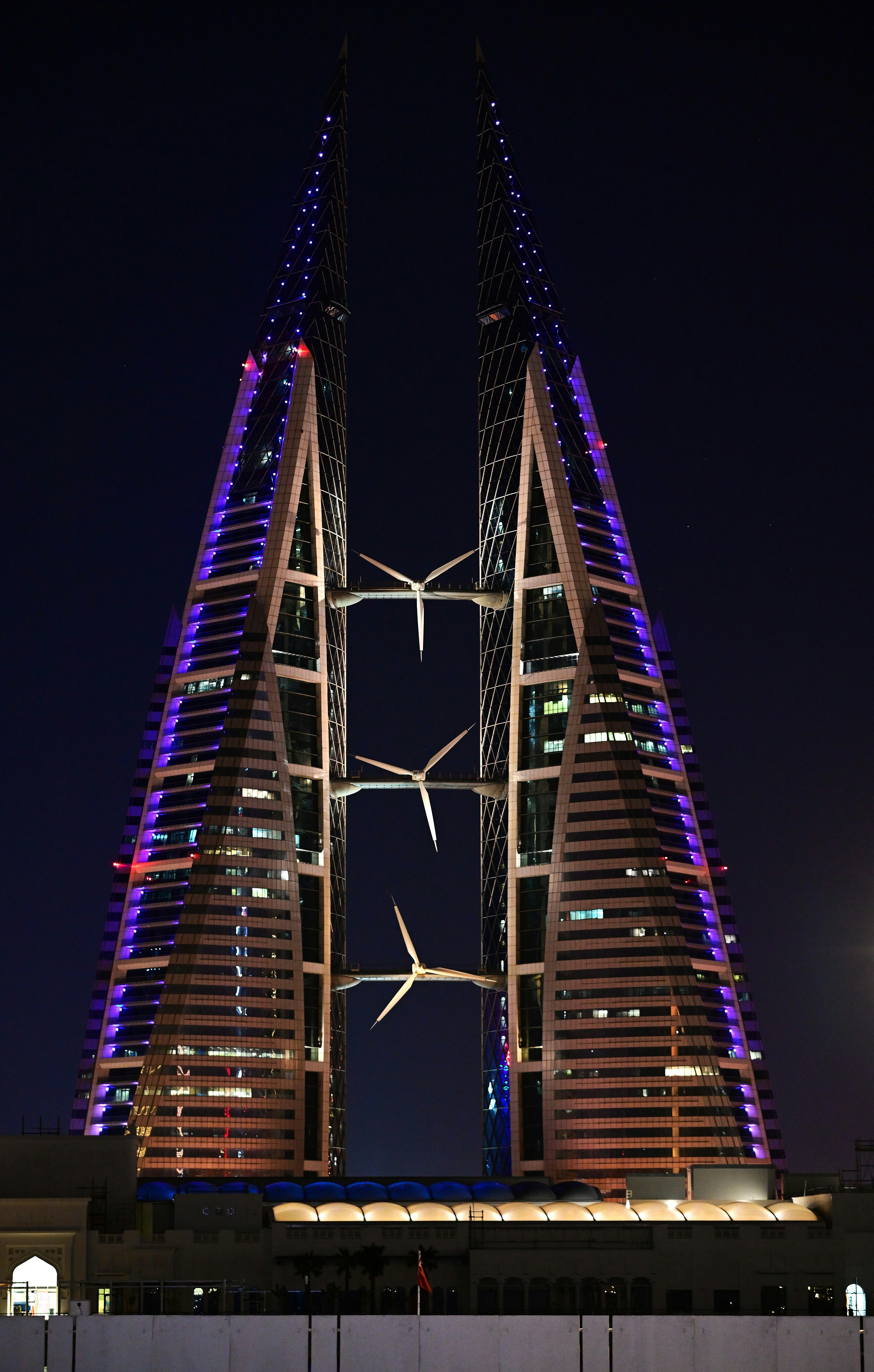 The illuminated bahrain world trade center at night.