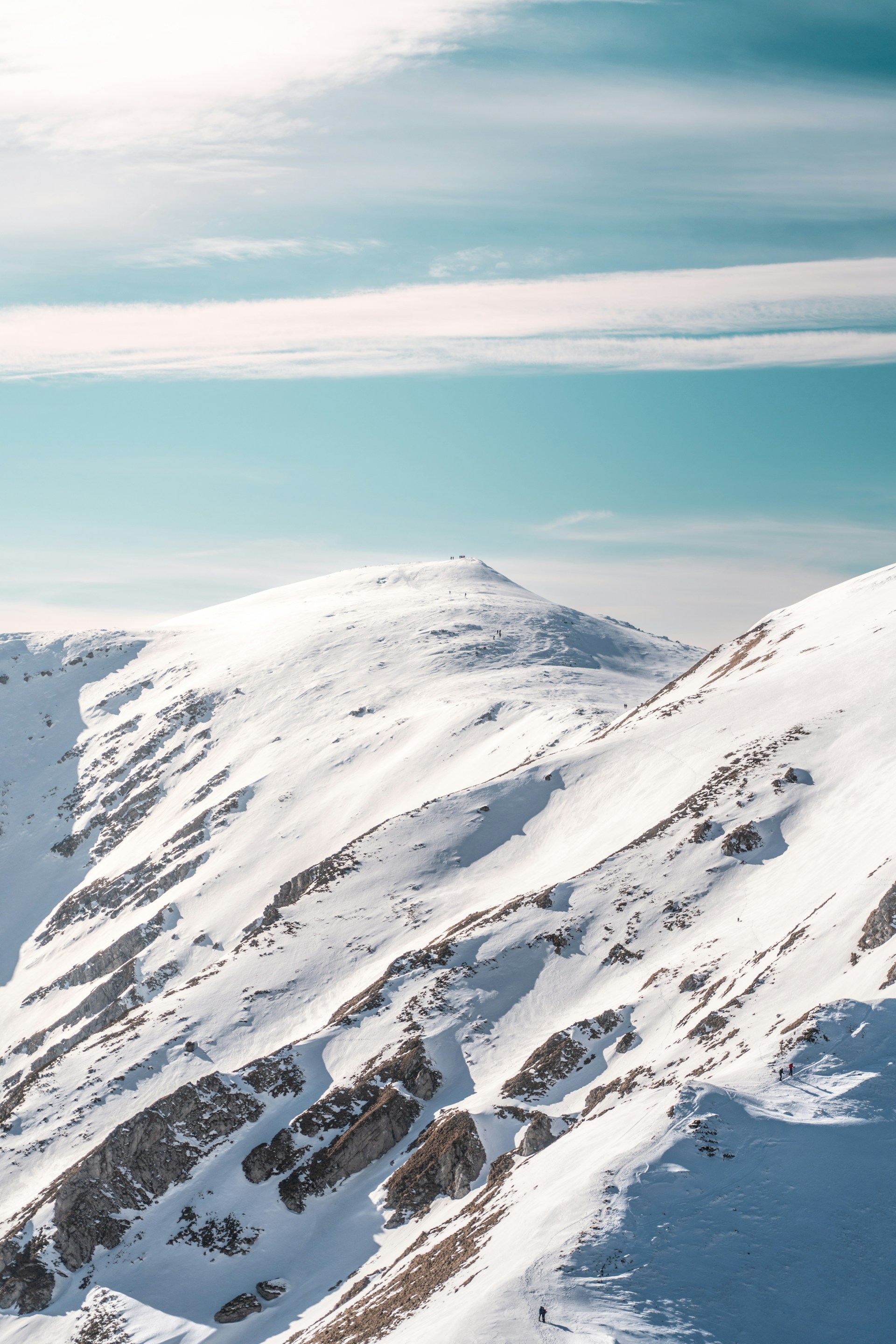 Snow-covered mountains under a bright blue sky.