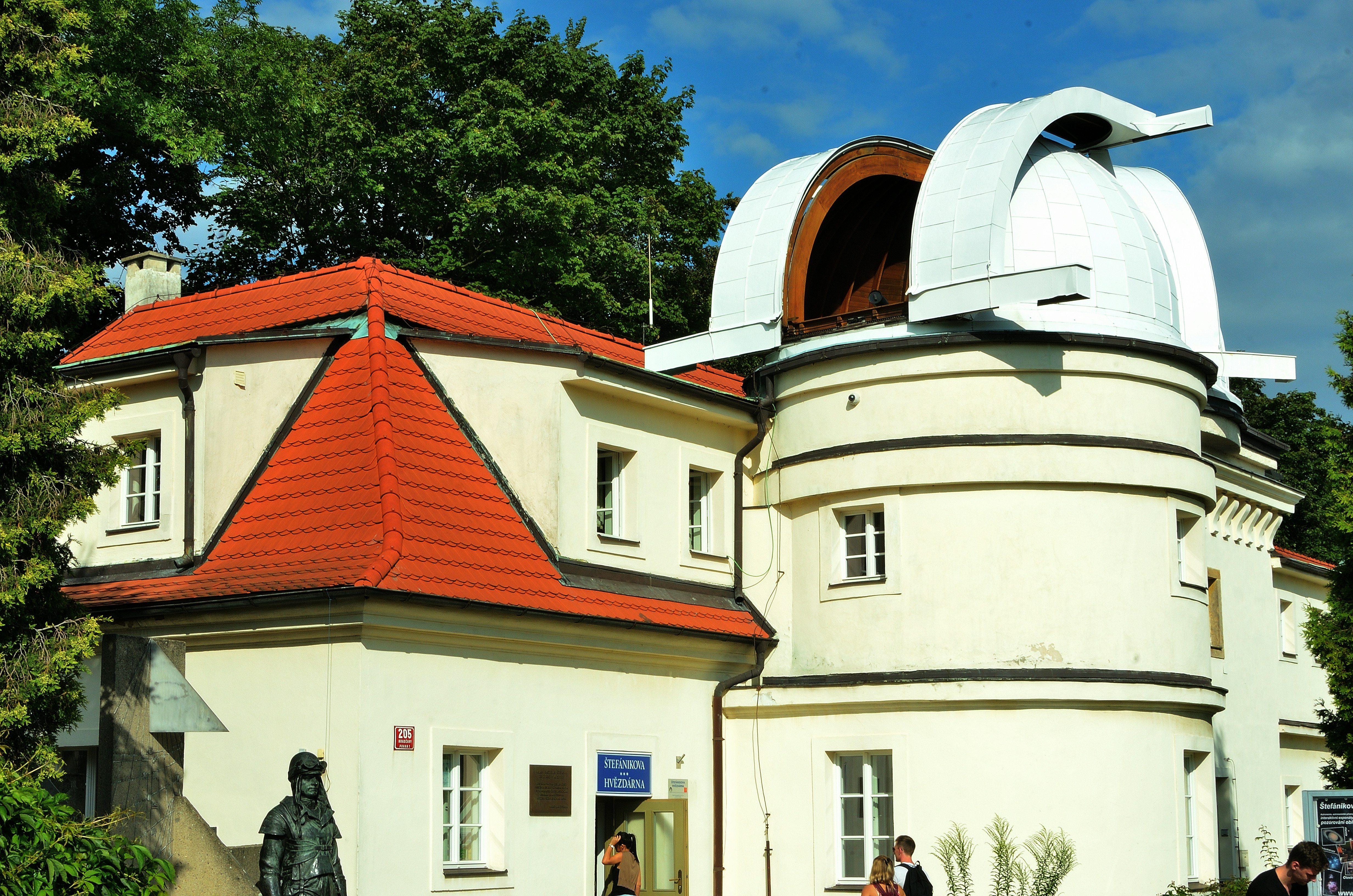 An observatory sits under a bright sky.