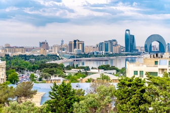 Cityscape with modern architecture under a cloudy sky.