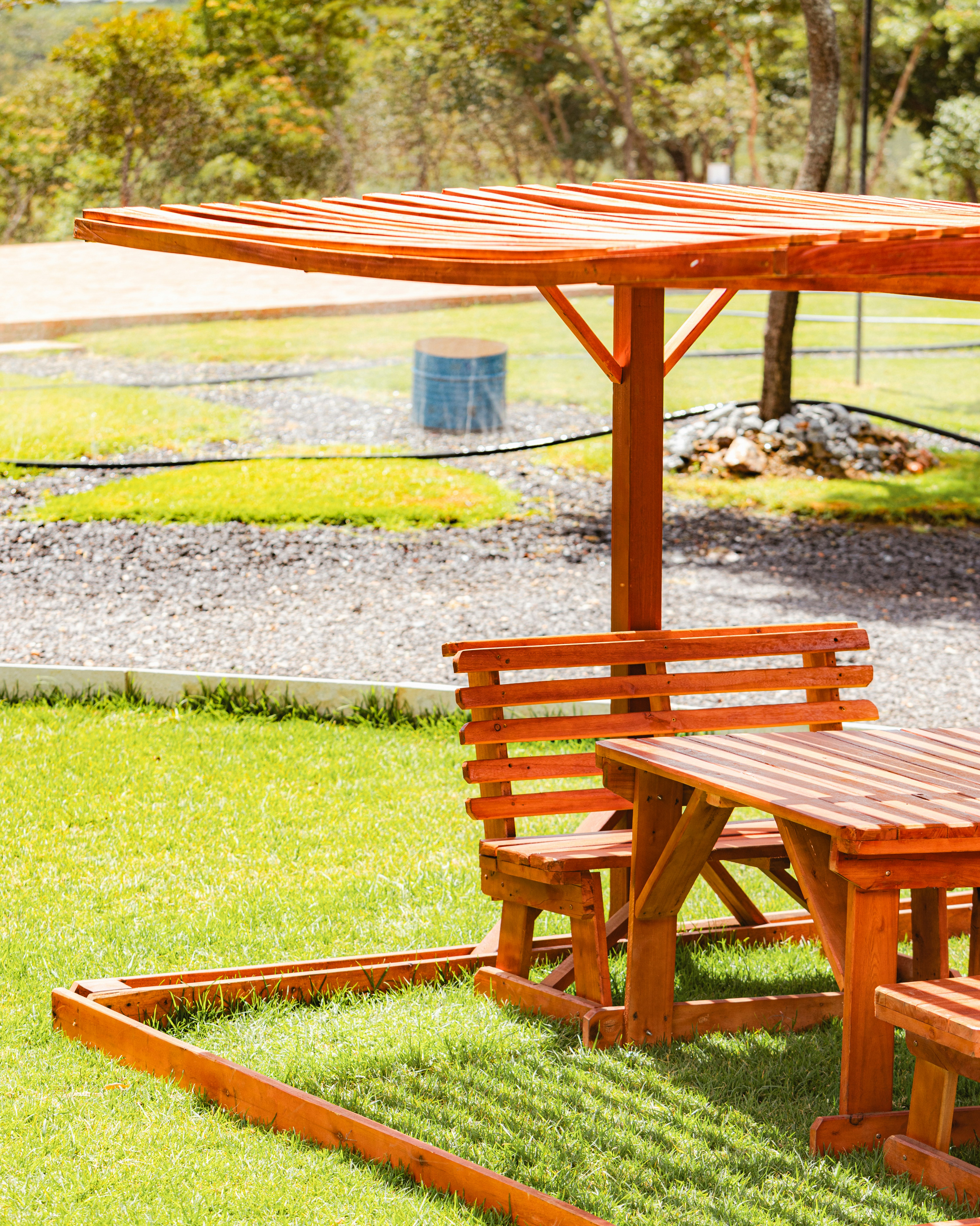 Picnic table and bench in the sunny outdoors.