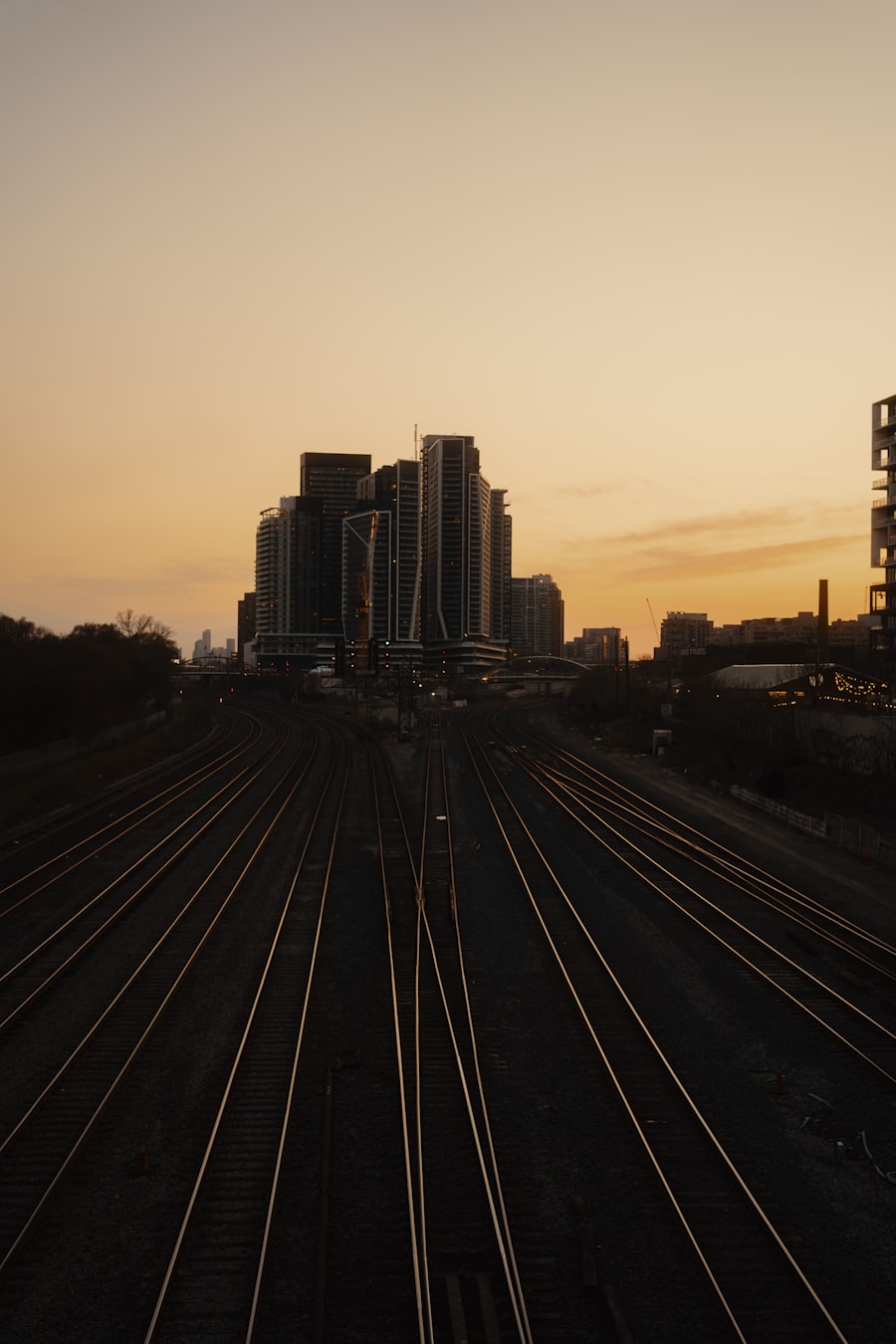 Railroad tracks leading to city skyline