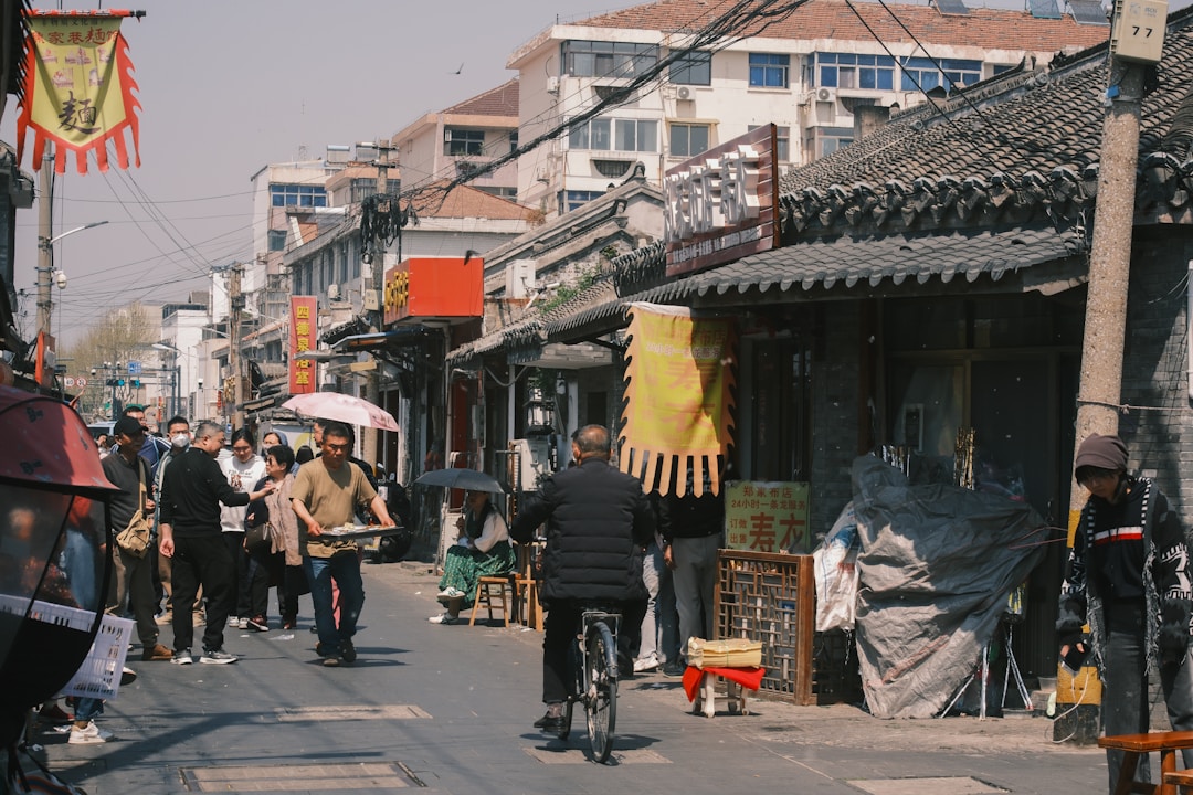 Morning street life in a Chinese residential neighborhood with small shops and food stalls coming to life at sunrise