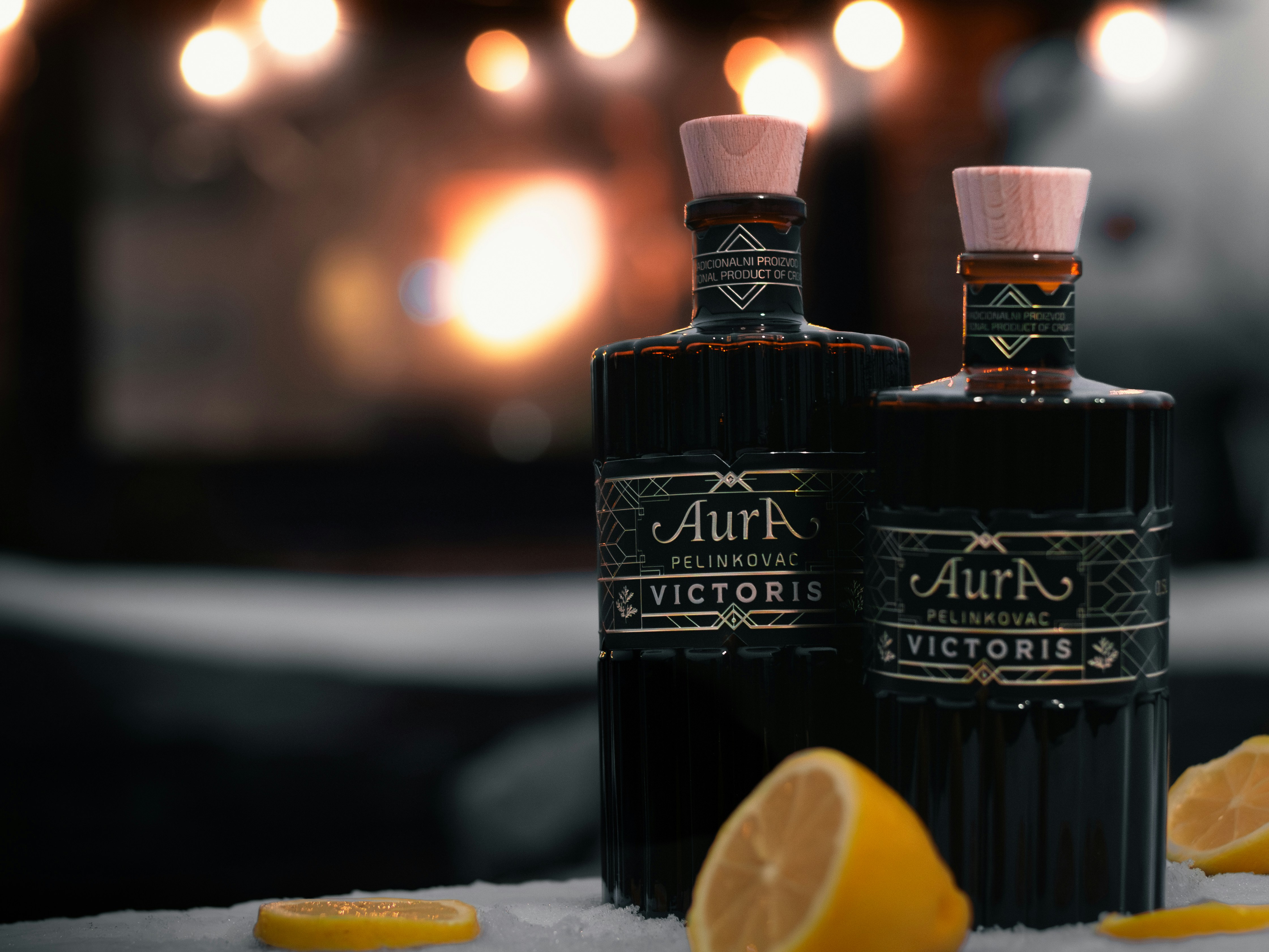 Bottles of liquor sit with lemon slices.