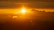 The sun shines through golden clouds.