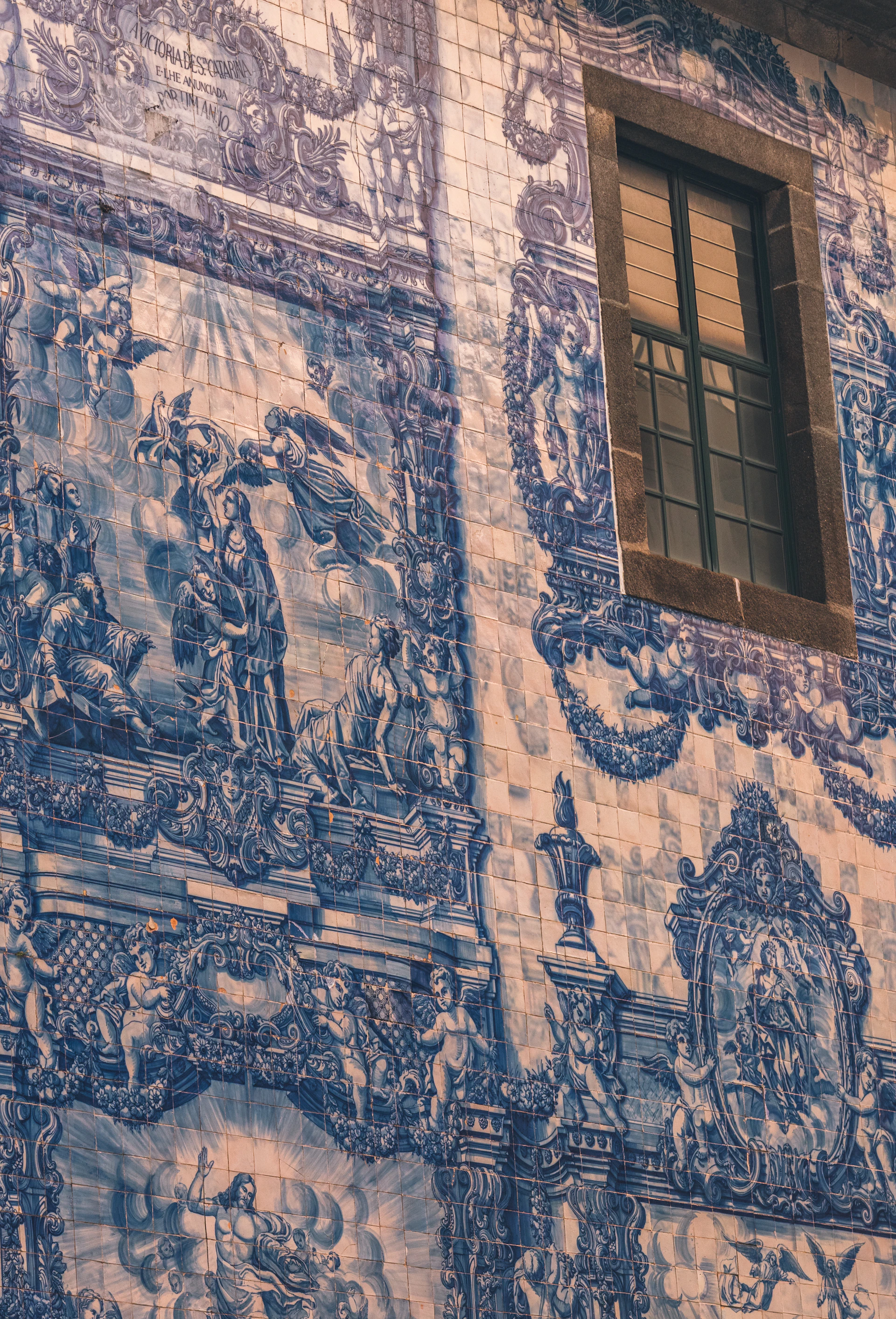 Blue and white tiles decorate a church wall.