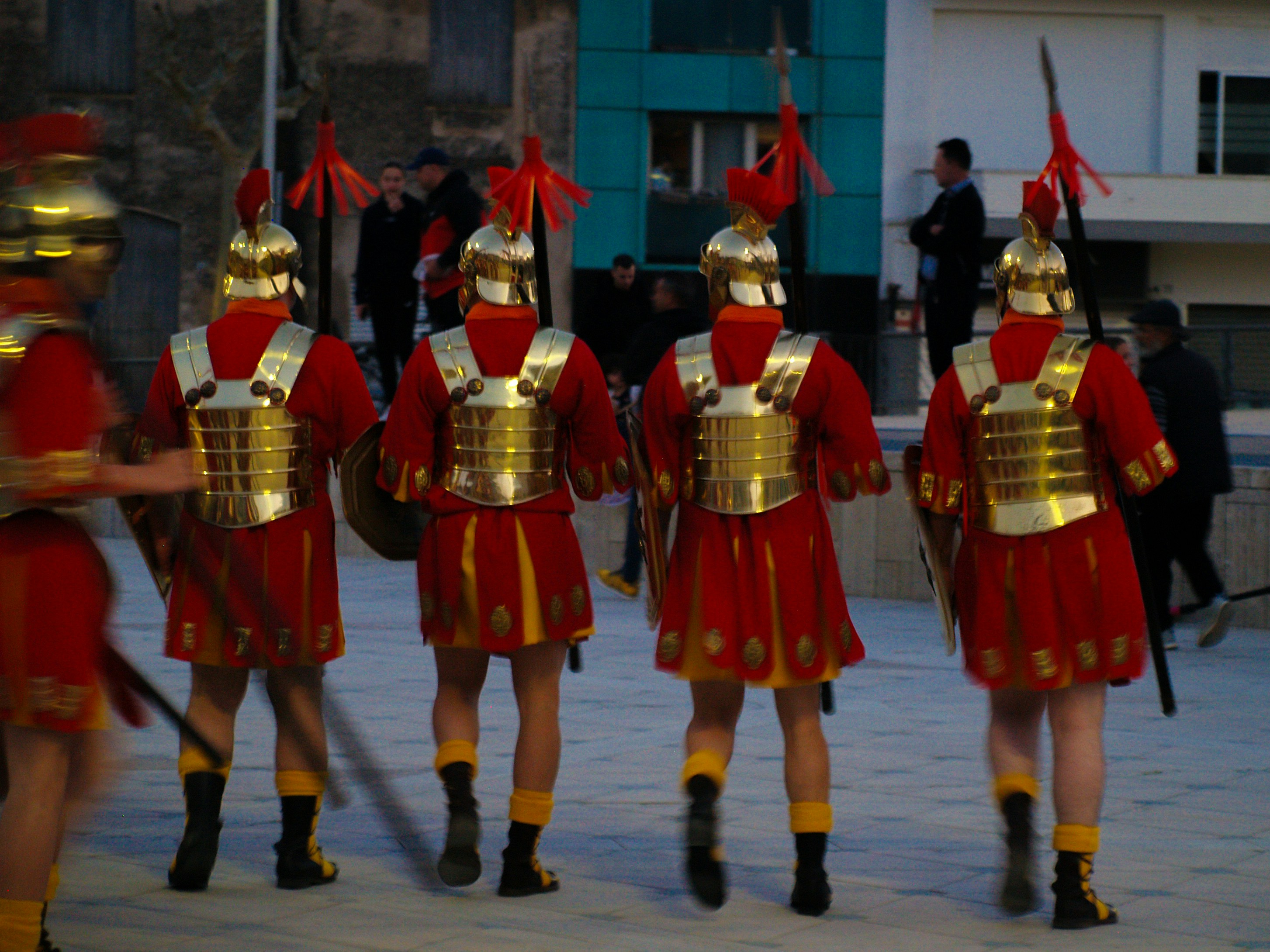 Roman soldiers march in formation.