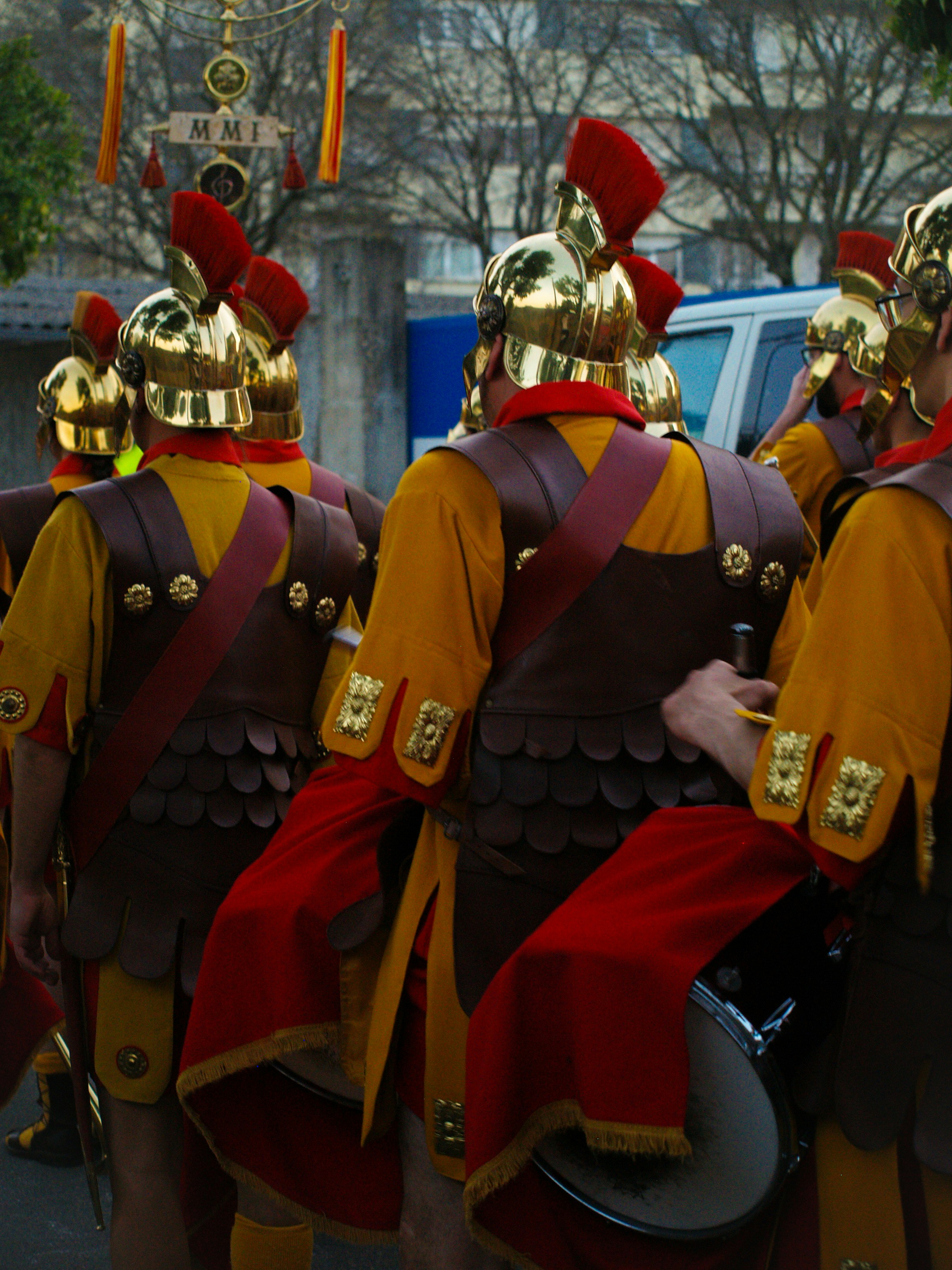 Roman soldiers marching in formation with vibrant uniforms.