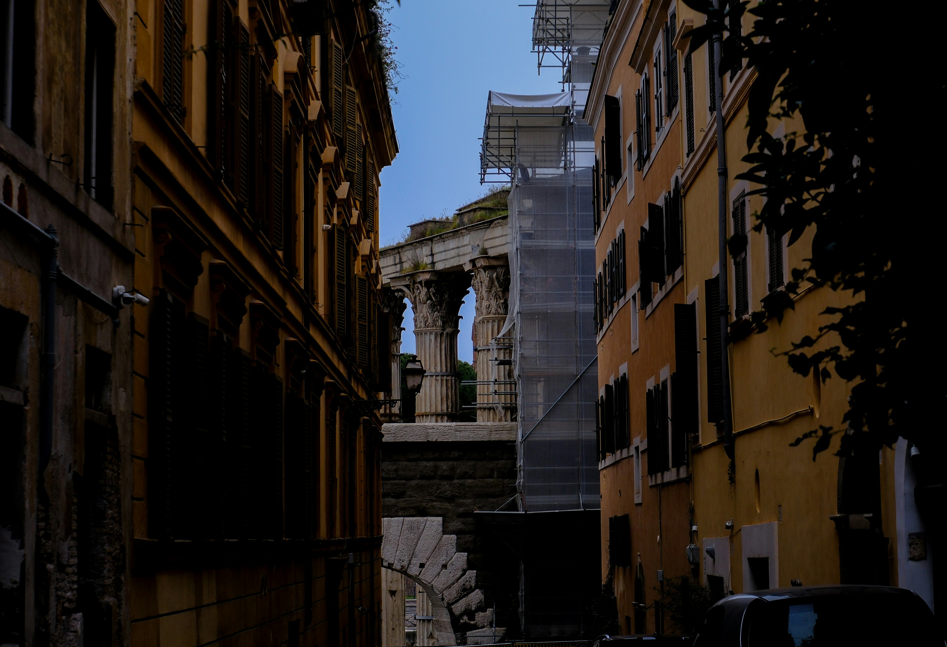 A historic building is seen through city buildings., 