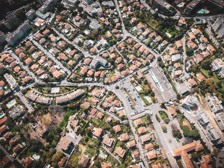 Aerial view of a suburban neighborhood with houses and winding roads