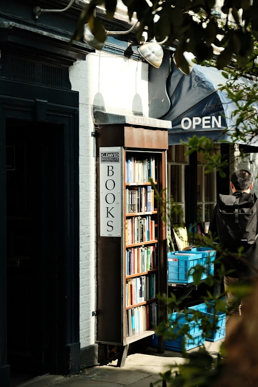 A bookshop with books stands open outside.