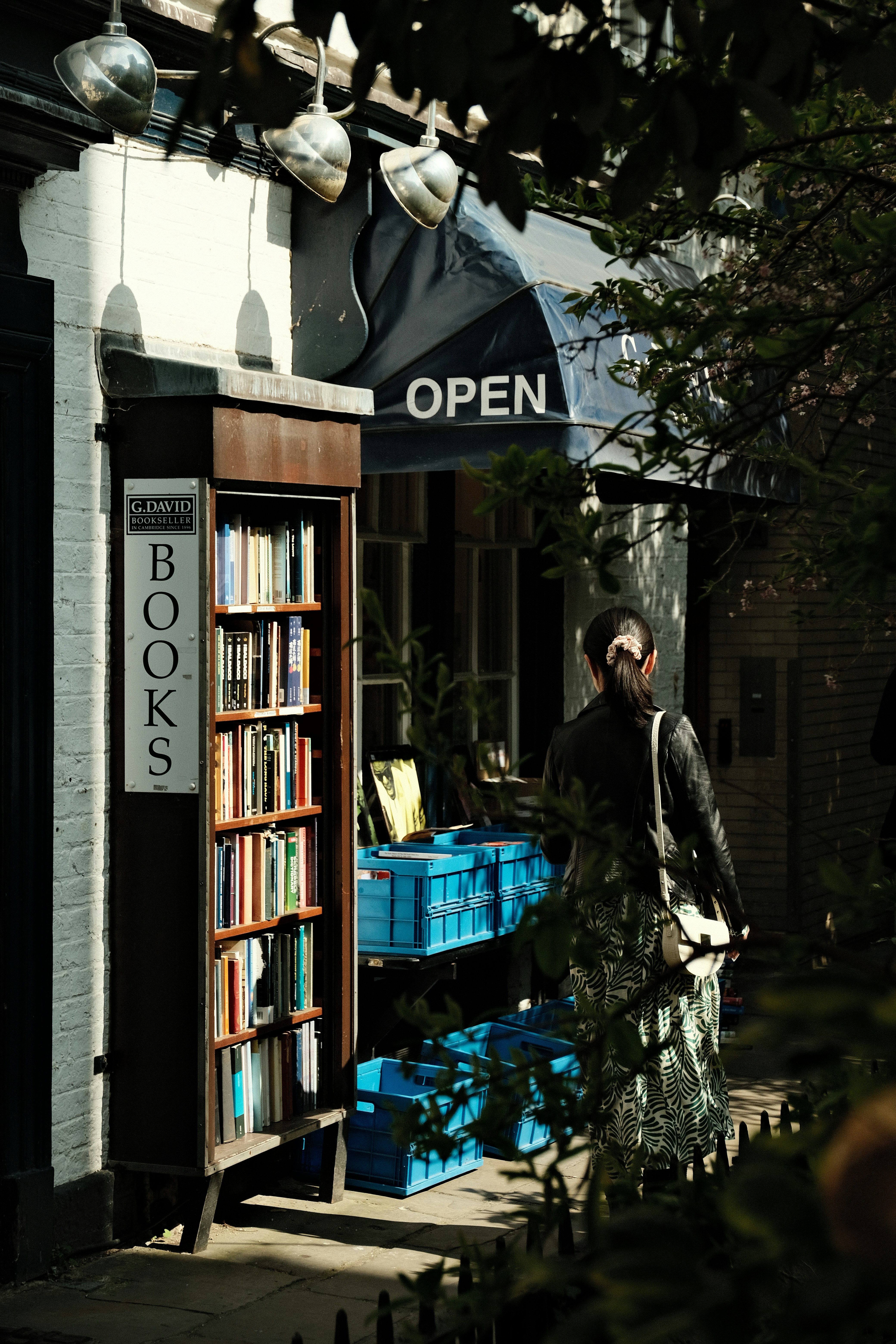 A bookstore is open, with books displayed outside.