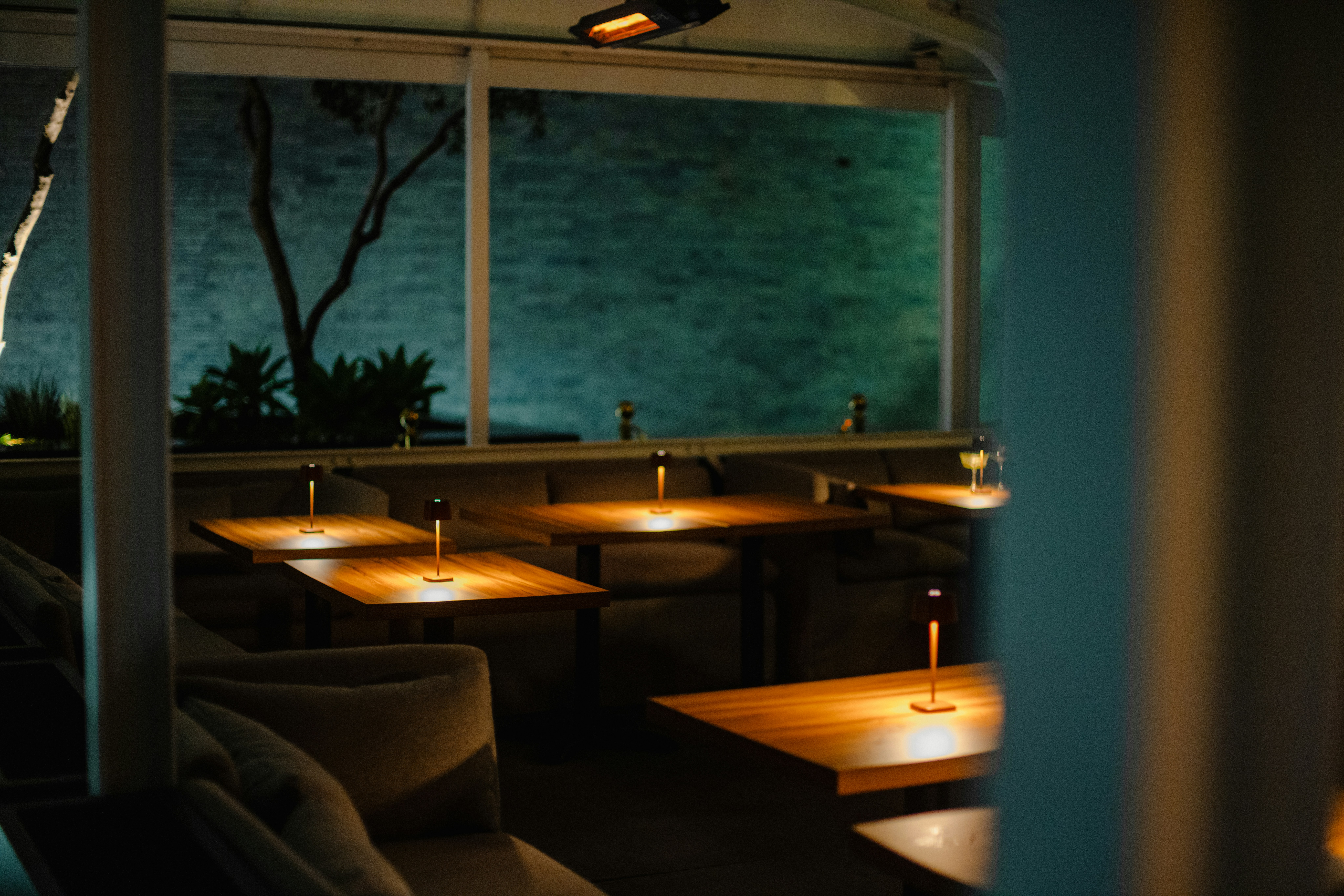 An evening scene at an outdoor restaurant.