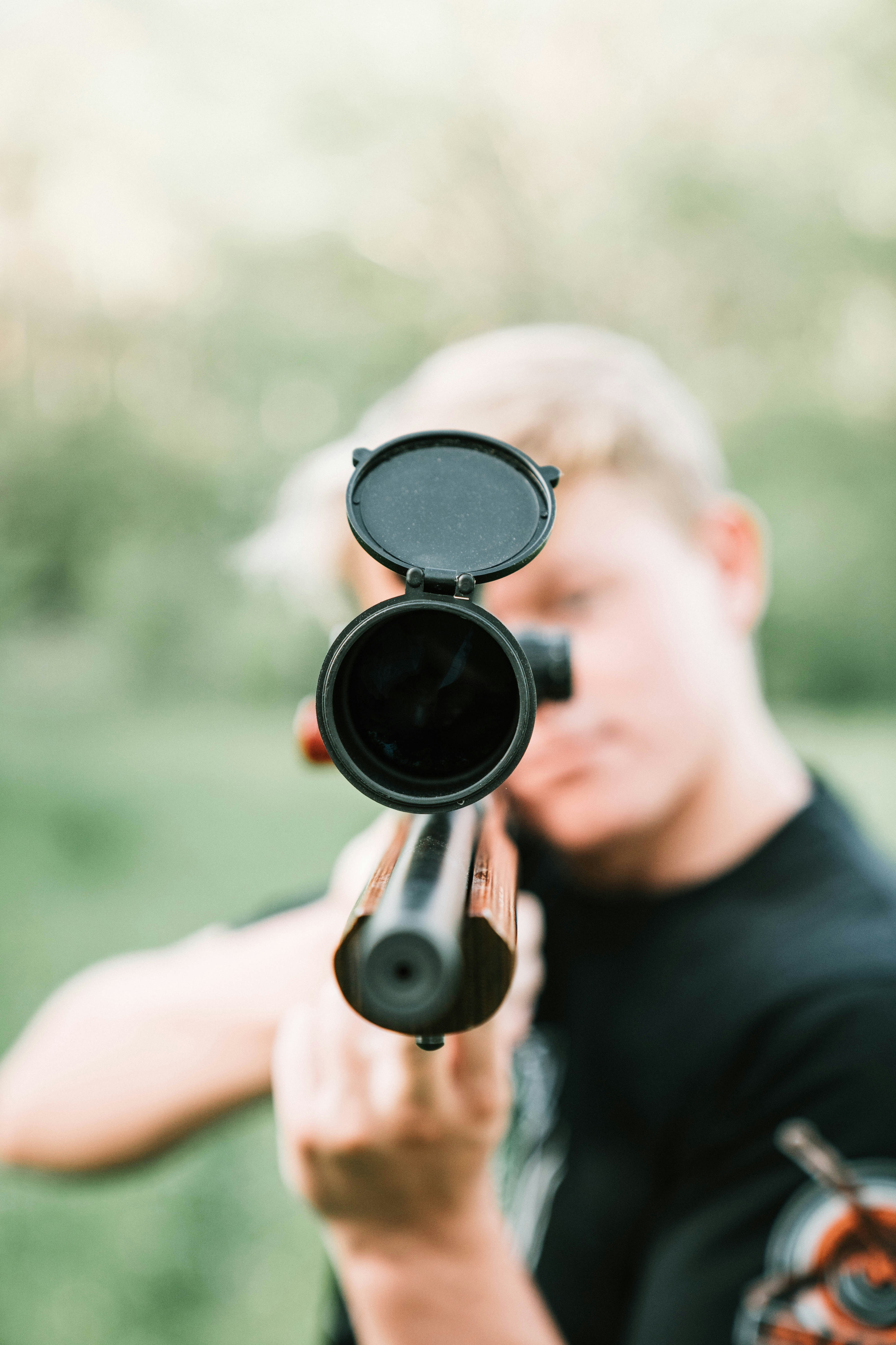 A person is aiming a rifle.