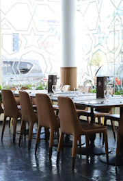An elegantly set restaurant table near a window.