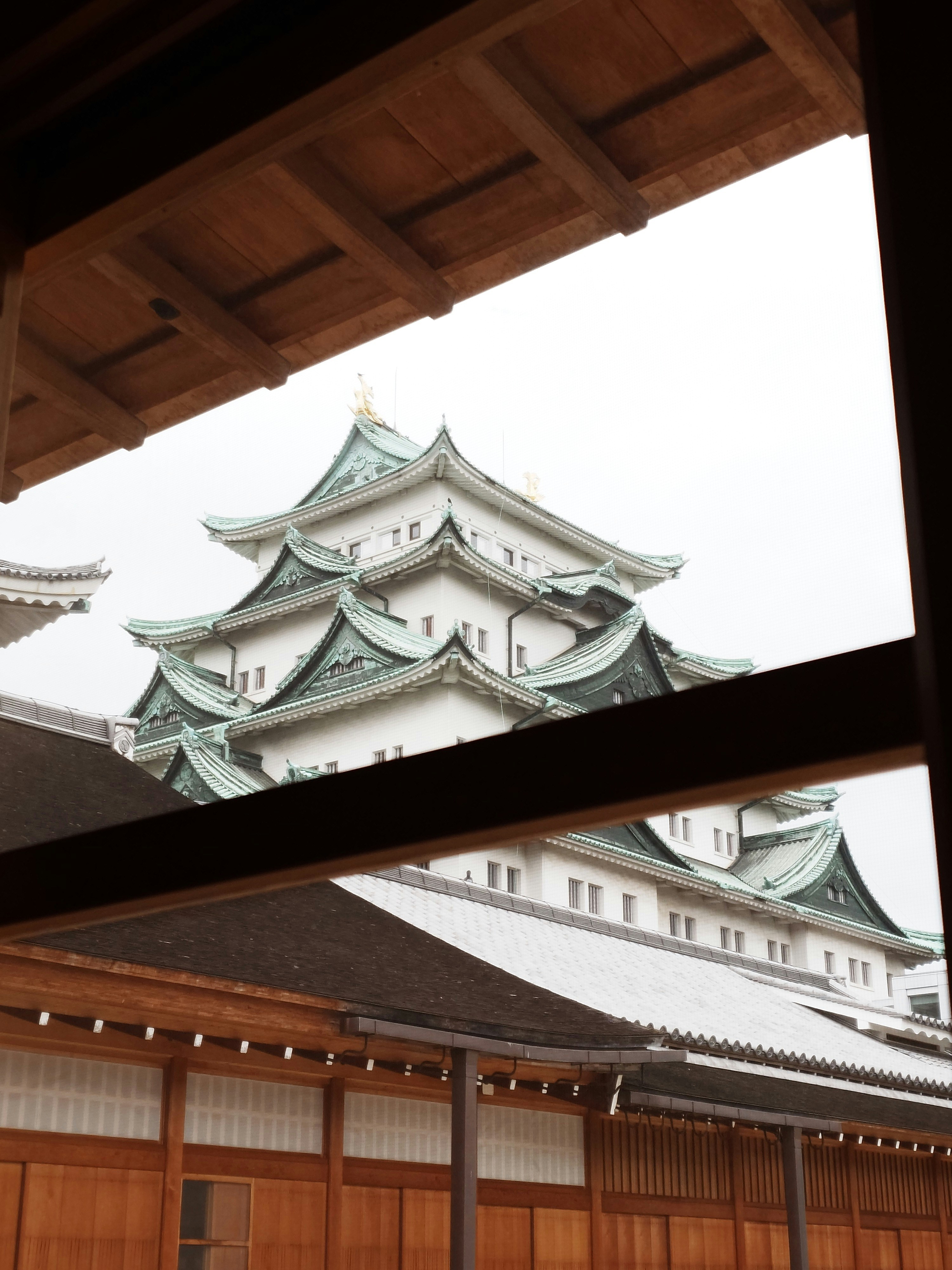 A japanese castle is framed by wooden structures. photo – Free Building ...