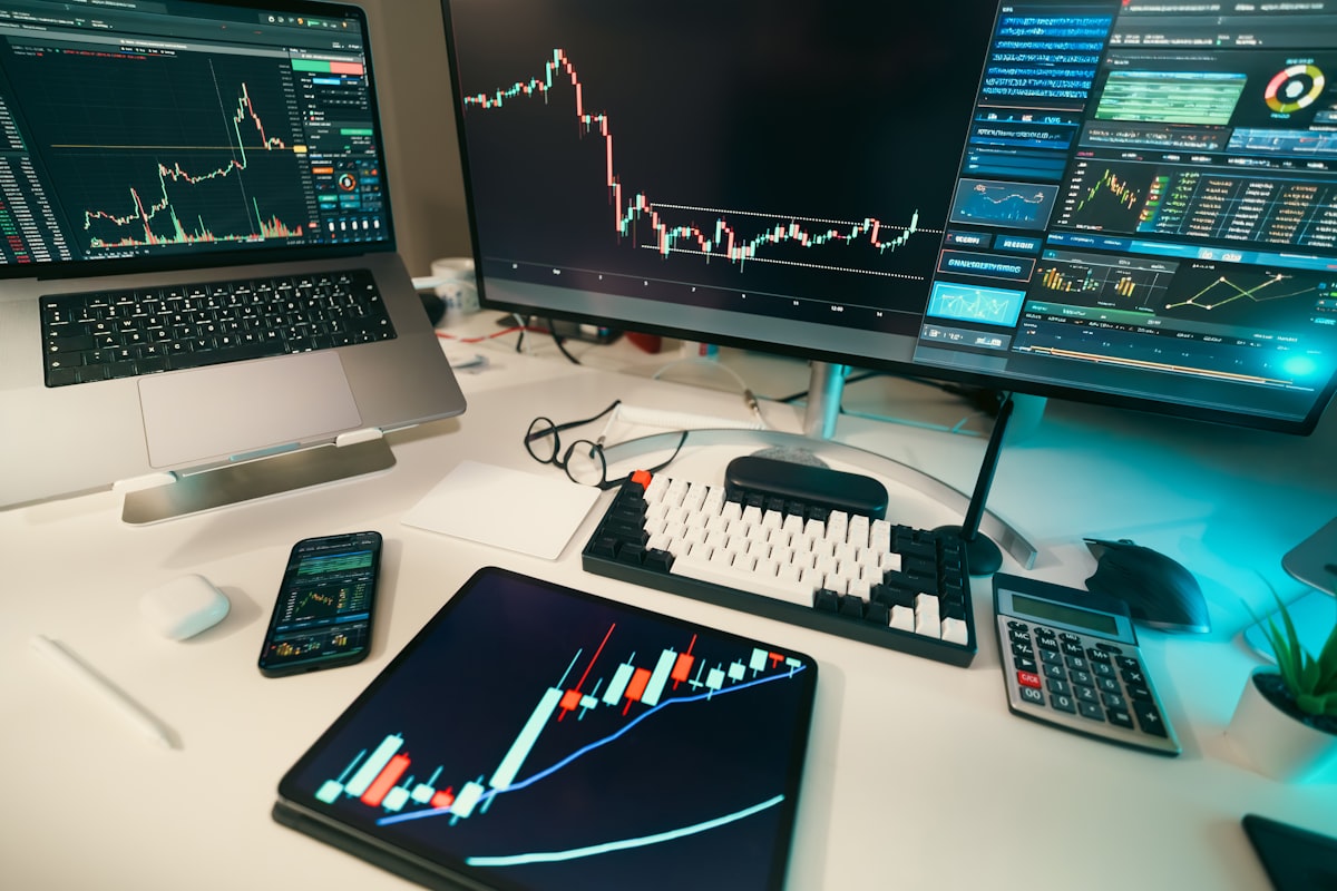Stock market trading charts displayed on multiple computer screens