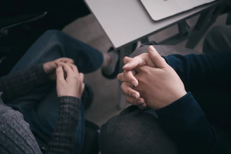 Two people are holding hands.