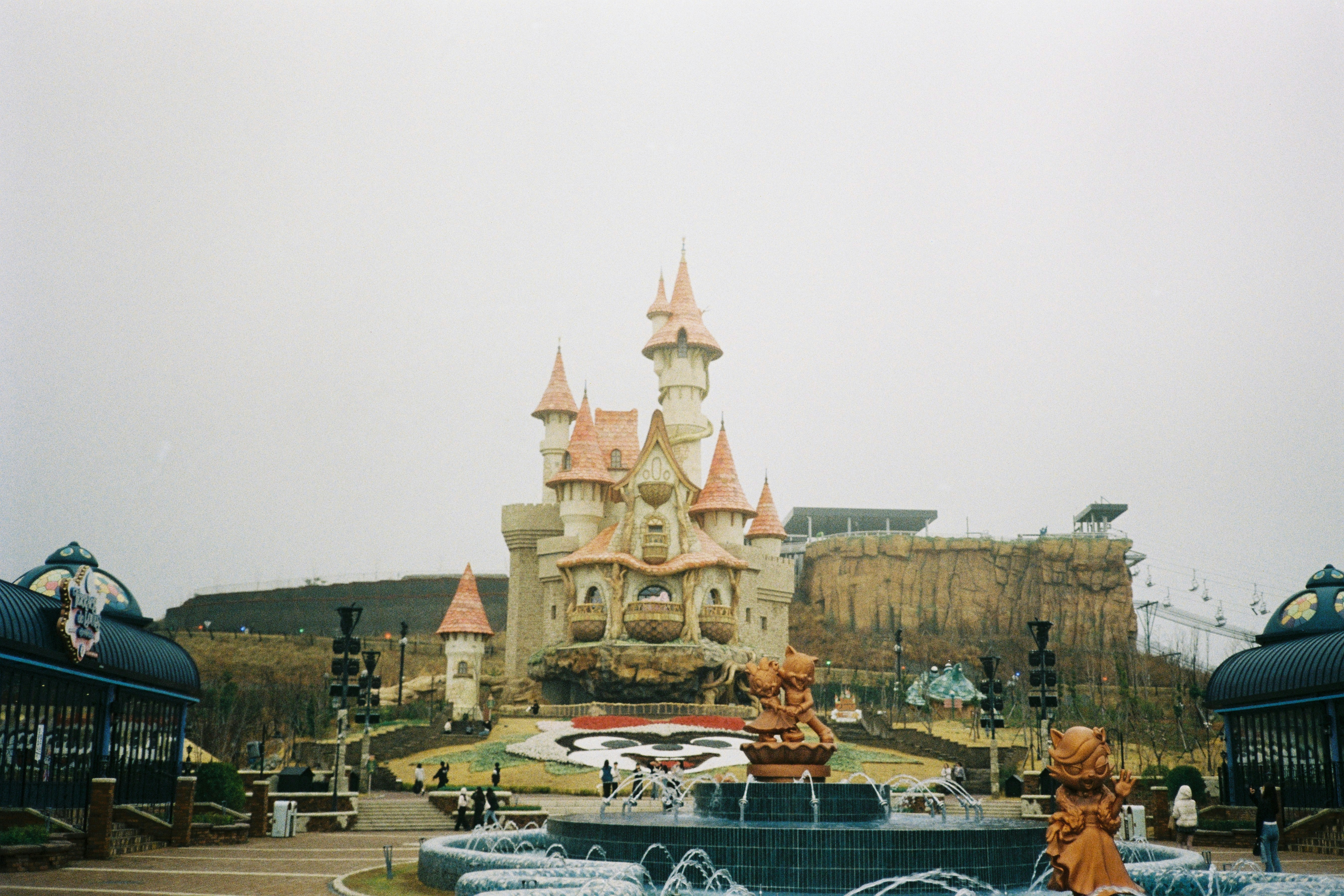 A beautiful castle stands in front of a fountain.