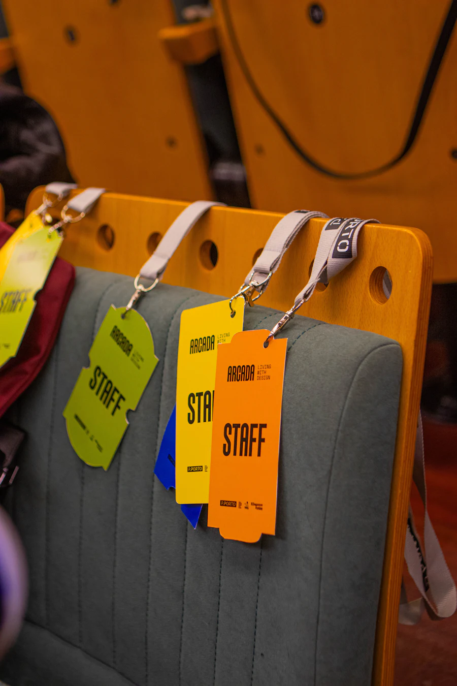Staff passes on lanyards hooked over the backs of theatre seats, in grainy black and white.