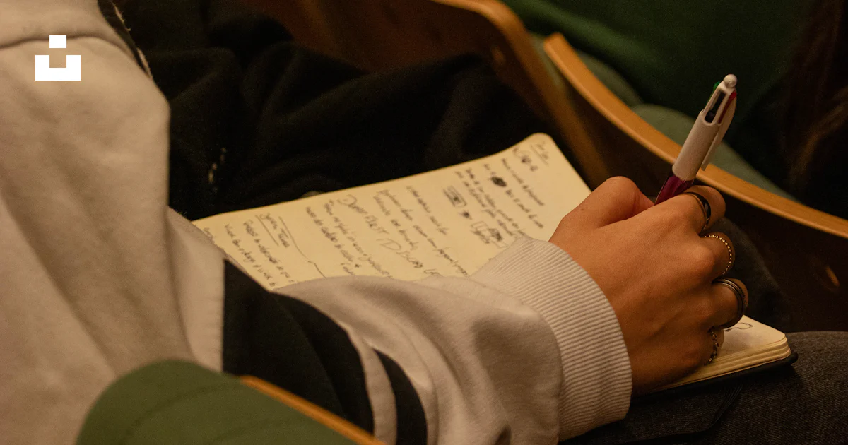 Someone is taking notes during a lecture. photo – Free Girl Image on ...