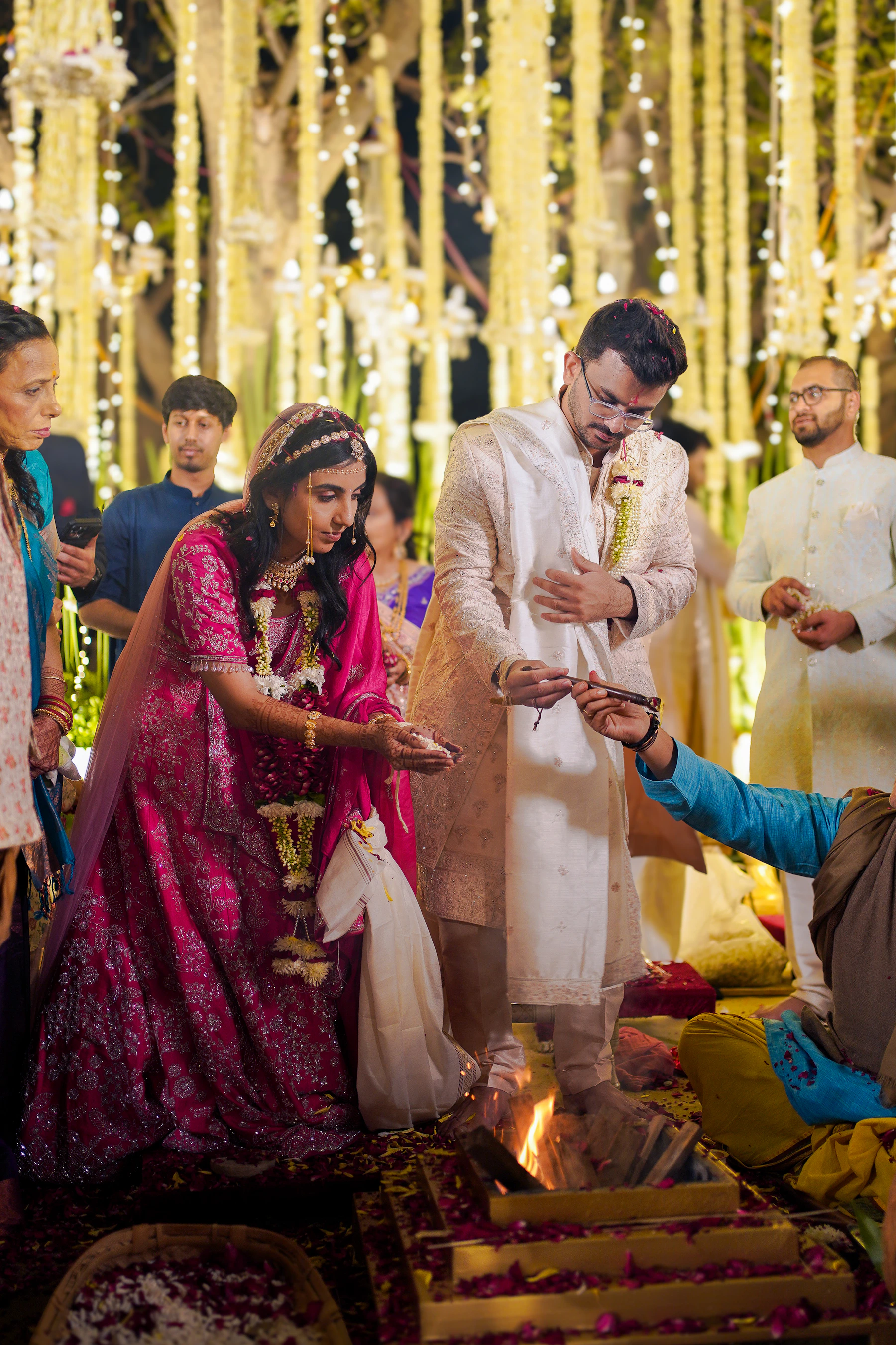 Indian bride and groom taking part in a Hindu wedding ritual beside a sacred fire