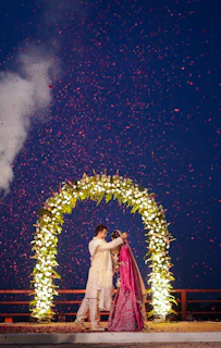Couple exchanges vows under a flower archway