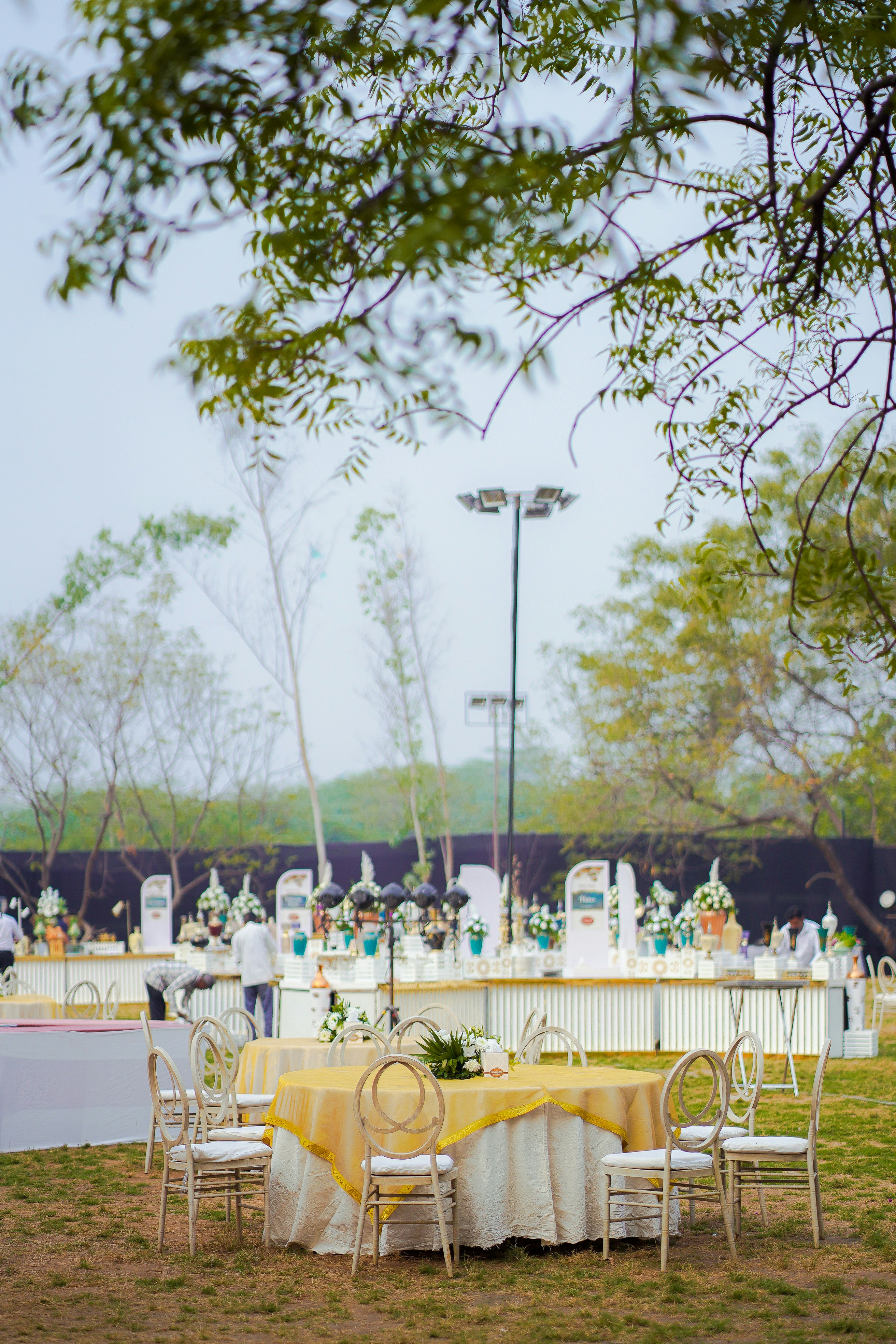 An elegant outdoor wedding reception is set.