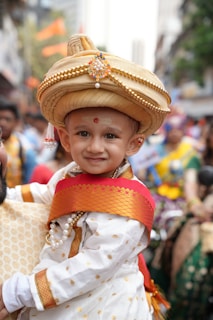 A cute child dressed in traditional indian attire.