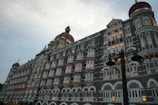 The taj mahal palace hotel shines in the evening.