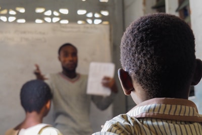 A teacher instructs students in a classroom.