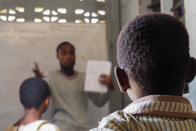 A teacher instructs students in a classroom.