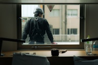 A construction worker looks out the window.