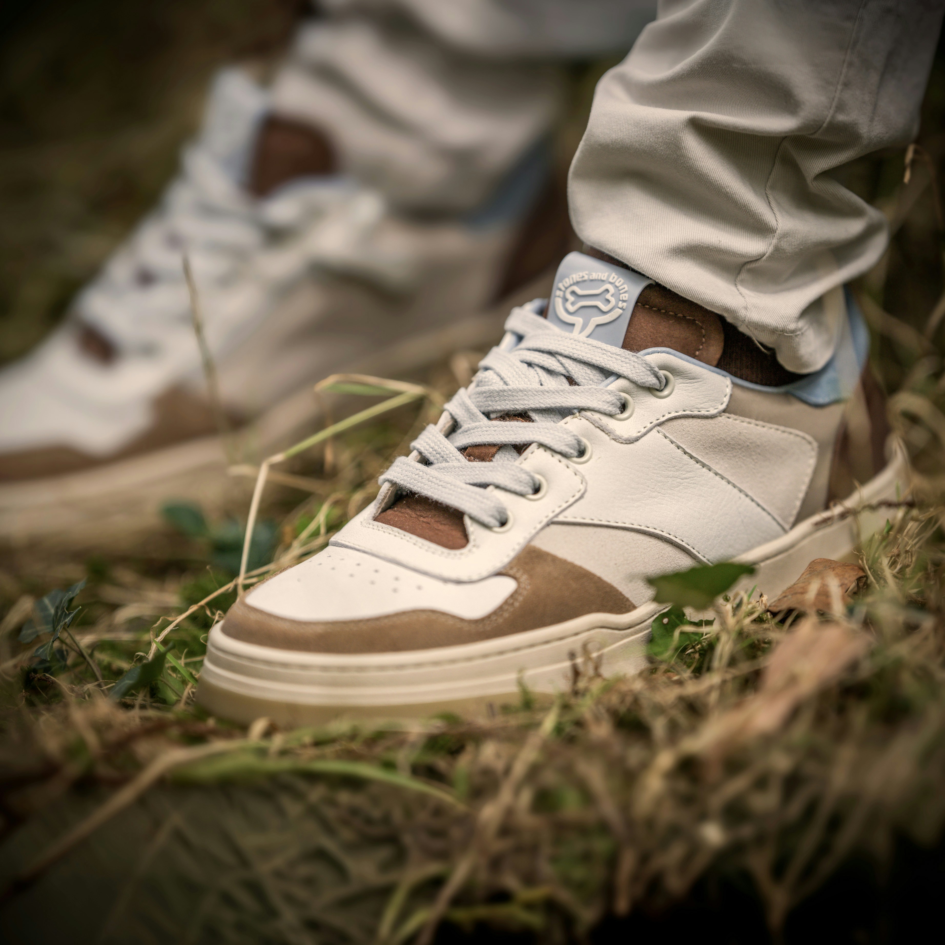 Stylish sneakers are shown outdoors, in close-up.