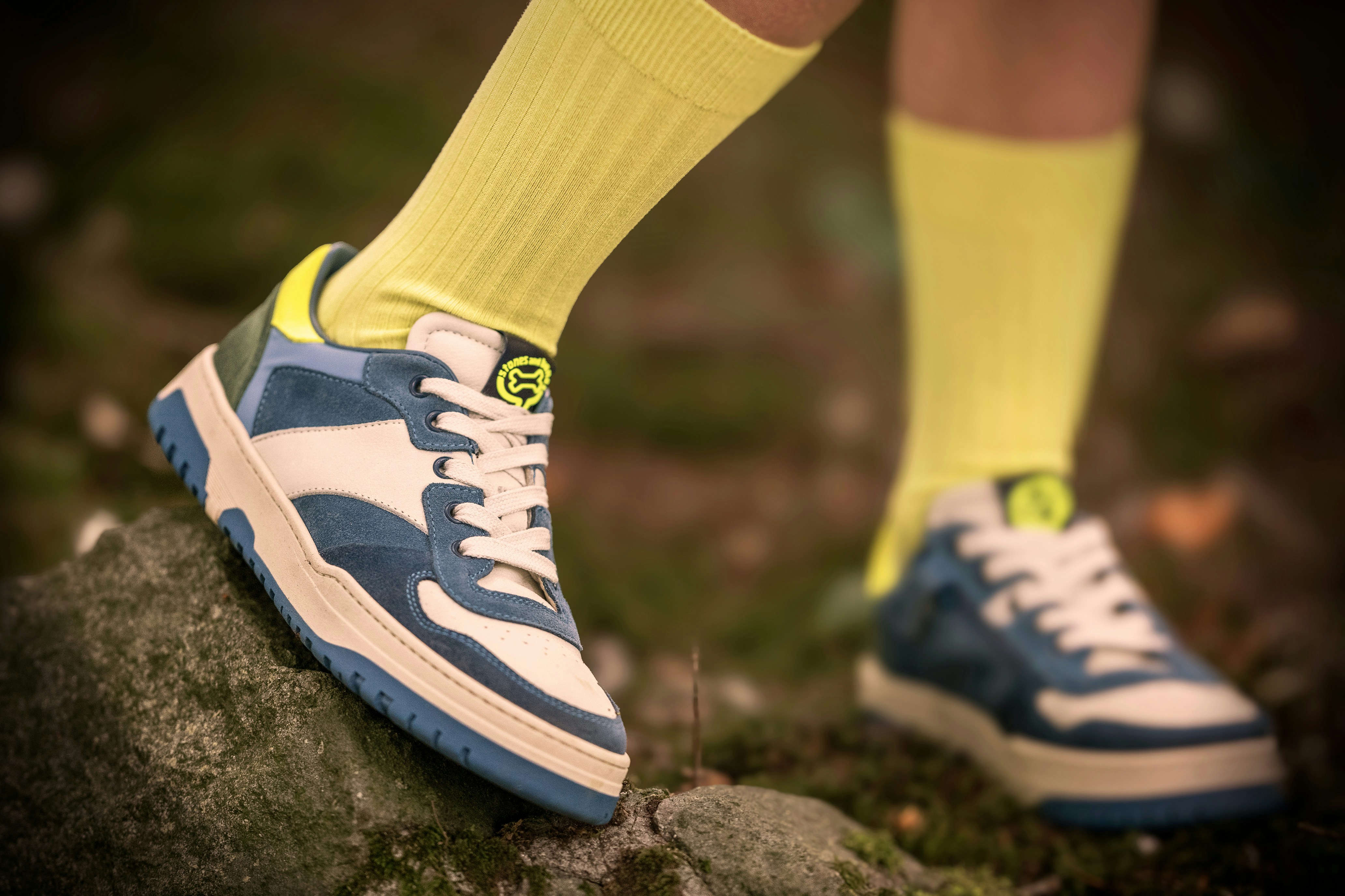 Person wears blue and white sneakers.