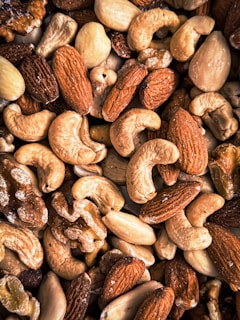 Various nuts are arranged close together in a pile.