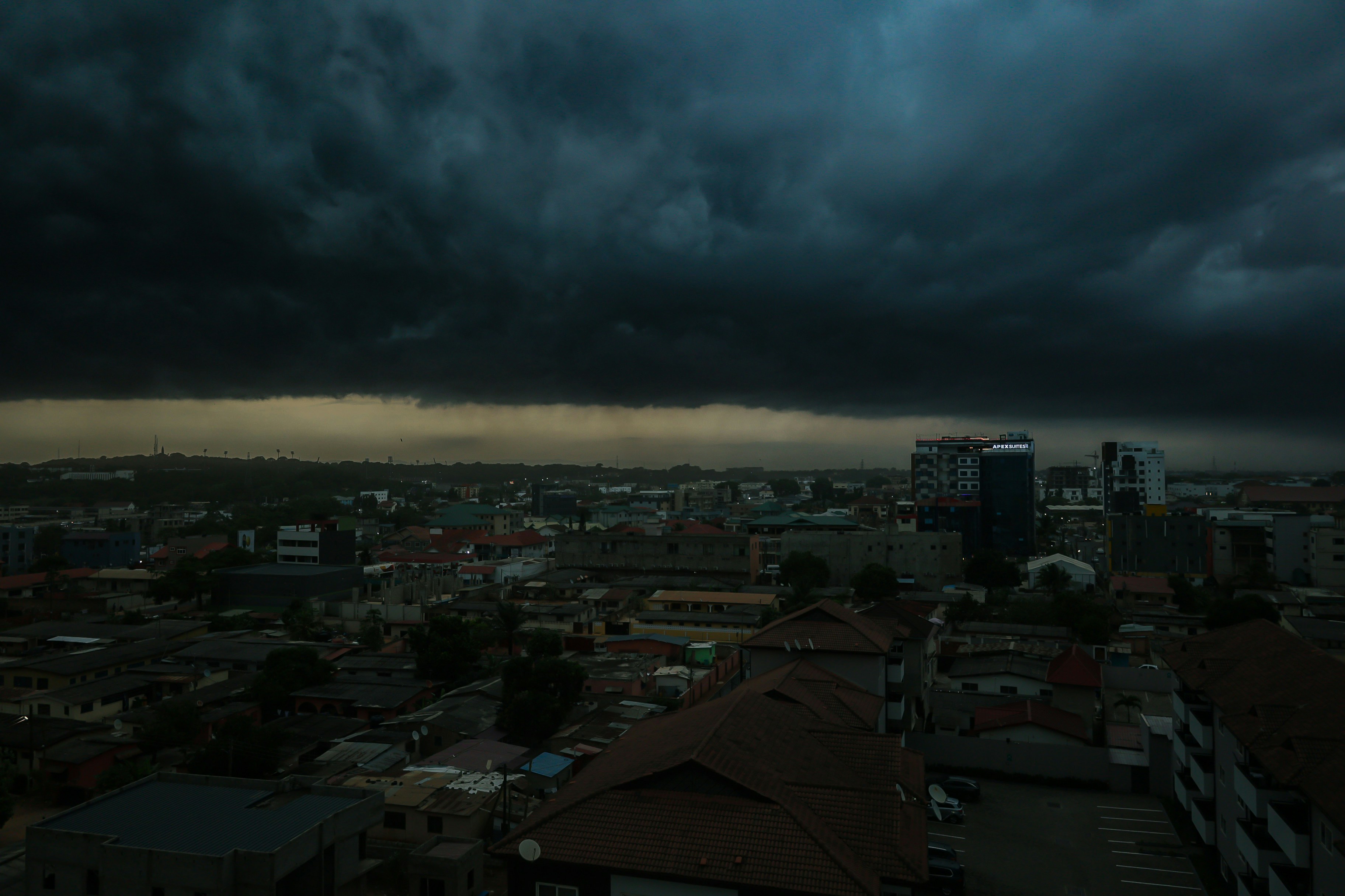 Dark clouds loom over a city skyline.
